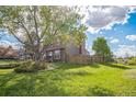 Spacious backyard featuring a lush green lawn and wooden privacy fence at 11321 N Brownstone Dr, Parker, CO 80138