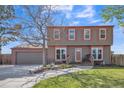 Charming two-story home with a well-manicured lawn and an attached two-car garage at 11321 N Brownstone Dr, Parker, CO 80138