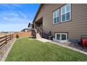 Well-maintained backyard with artificial grass, and wood fence around perimeter, perfect for outdoor entertaining at 4475 Hidden Gulch Rd, Castle Rock, CO 80104