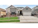 Charming two-story home featuring a well-manicured lawn, complemented by a two-car garage and inviting entrance at 9028 S Catawba St, Aurora, CO 80016
