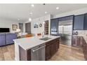 This spacious kitchen boasts stainless steel appliances, a center island with bar seating, and a walk-in pantry at 9028 S Catawba St, Aurora, CO 80016