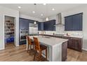 Modern kitchen with stainless steel appliances, granite countertops, and a spacious center island with bar stool seating at 9028 S Catawba St, Aurora, CO 80016
