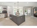 Open kitchen with center island, breakfast bar, and access to the dining area at 18 Foxtail Cir, Englewood, CO 80113