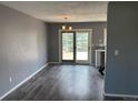 Open dining area with laminate flooring, modern lighting, and sliding door access to the deck at 3613 S Olathe St, Aurora, CO 80013