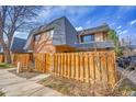 Close-up of townhome exterior with wood privacy fences, and an attractive facade at 7995 E Mississippi Ave # C1, Denver, CO 80247