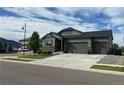 Single-Gathering home boasts three-car garage, appealing stone accents, and manicured landscaping at 5204 Lake Port Ave, Longmont, CO 80504