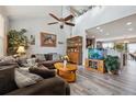 Open living room featuring vaulted ceiling, ceiling fan, and lots of natural light at 11883 E 111Th Ave, Commerce City, CO 80640