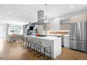 Modern kitchen with stainless steel appliances, large island with seating, and open to living room at 2242 W 34Th Ave, Denver, CO 80211