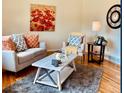Bright living room features a cozy couch, chair, stylish rug, and decor at 1687 S Field Ct, Lakewood, CO 80232