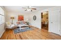 Cozy living room featuring hardwood floors, a ceiling fan, and a view into the dining room at 1687 S Field Ct, Lakewood, CO 80232