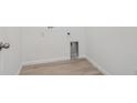 The laundry area with hookups and base trim, offering a functional space at 45928 Gentry Ave, Bennett, CO 80102