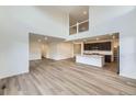 Open-concept living space features wood floors, modern finishes, and seamless access to the kitchen at 4586 Windmill Dr, Brighton, CO 80601