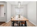 Dining room featuring a light wood table with seating for six and a stylish light fixture at 17801 E 95Th Pl, Commerce City, CO 80022