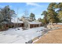 Two story home with a three car garage and snowy driveway at 3028 Olympia Cir, Evergreen, CO 80439