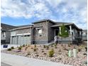 Attractive home with stone accents, a welcoming front porch, and low maintenance landscaping at 3966 Doubletrack Ln, Castle Rock, CO 80108