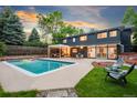 Gorgeous backyard oasis with a sparkling pool, patio area, and modern home design at 1440 S Dahlia St, Denver, CO 80222
