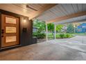 Covered carport showcasing a unique door and convenient access to the home's entry at 1440 S Dahlia St, Denver, CO 80222