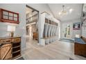 Spacious mudroom with custom built-in storage, wood accents, and a view into the open-concept living space at 14887 W 49Th Pl, Golden, CO 80403