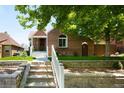 Inviting brick home featuring landscaped steps up to the house at 3036 Birch St, Denver, CO 80207