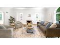 Cozy living room featuring fireplace, neutral decor, and natural light at 3036 Birch St, Denver, CO 80207