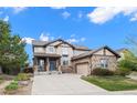 Charming two-story home with stone accents, an attached garage, and a manicured front lawn at 6475 S Newcastle Way, Aurora, CO 80016