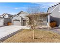 Charming exterior features a welcoming front porch, well-maintained lawn, and a three car garage at 2187 Pineywoods St, Mead, CO 80542