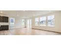 Bright living room with hardwood floors, large windows, and sliding glass doors to the backyard at 39816 Floyd St, Elizabeth, CO 80107