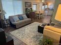 Bright living room featuring large window, and dining area with wood floors at 1829 S Lee St # C, Lakewood, CO 80232