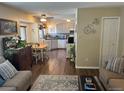 Open living area with ample natural light, wood floors, and eat-in kitchen at 1829 S Lee St # C, Lakewood, CO 80232