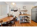 Bright kitchen with a wooden dining table, wooden floors, and a stainless steel refrigerator at 1390 N Emerson St # 406, Denver, CO 80218