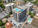 Aerial shot of modern high-rise condo building featuring a rooftop pool and ample parking at 790 N Washington St # 1210, Denver, CO 80203