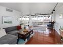 Bright living room with hardwood floors, comfortable seating, and sliding glass doors to a balcony at 790 N Washington St # 1210, Denver, CO 80203