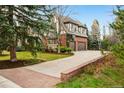 Long private driveway leading to a three-car garage with a basketball hoop at 17 Polo Club Dr, Denver, CO 80209