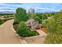 Aerial view of a charming two-story home with a well-manicured lawn nestled in a lush, green neighborhood at 301 Widgeon Ln, Longmont, CO 80503