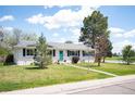 Charming ranch-style home with a well-maintained lawn and inviting turquoise front door at 986 S Jersey St, Denver, CO 80224