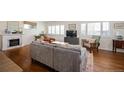 Bright, open living space features hardwood floors and a charming fireplace with decor at 986 S Jersey St, Denver, CO 80224