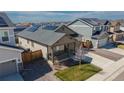 View of a single-Gathering home with gray siding and a cozy front porch in a residential neighborhood at 915 N Waterloo Ct, Aurora, CO 80018