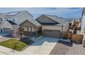 Inviting single-Gathering home boasts a two-car garage, front porch, and professionally landscaped yard at 915 N Waterloo Ct, Aurora, CO 80018