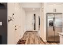 Bright entryway with wood-look floors and stainless steel refrigerator at 9308 Inca Dove Cir, Littleton, CO 80125