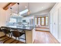 Bright kitchen features an island with seating, stainless steel appliances, and a window seat at 13830 Silverton Dr, Broomfield, CO 80020