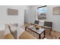 Bright living room with modern furnishings and a large window offering neighborhood views and natural light at 2205 E 25Th, Denver, CO 80205