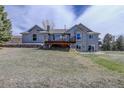 Beautiful backyard with a spacious deck, patio, and lush green grass at 10510 Inspiration Dr, Parker, CO 80138