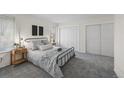Calm bedroom with a metal frame bed, soft gray bedding, and ample closet space for storage at 1280 Sable Blvd, Aurora, CO 80011