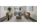 Cozy living room featuring modern furniture, neutral tones, and a large window that provides great light at 1280 Sable Blvd, Aurora, CO 80011