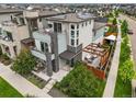 Modern three-story home with balconies, solar panels, and a deck area perfect for outdoor entertaining at 9391 E 59Th North Pl, Denver, CO 80238