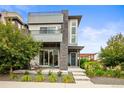 Charming three-story home with a covered front porch and modern architectural details at 9391 E 59Th North Pl, Denver, CO 80238