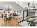 Bright, open kitchen featuring an island with bar seating, modern appliances, and a staircase at 9391 E 59Th North Pl, Denver, CO 80238