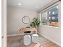 Office space featuring desk, round mirror, contemporary light fixtures and large window at 4733 E Iliff Ave, Denver, CO 80222