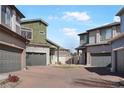 Exterior showcasing a community of homes with well-kept brick driveways and green spaces at 19055 E 55Th Ave, Denver, CO 80249