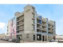 Exterior view of a modern urban apartment building with balconies and colorful mural art at 3198 Blake St # 502, Denver, CO 80205